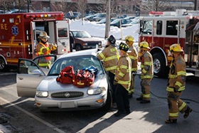 firemen by a car